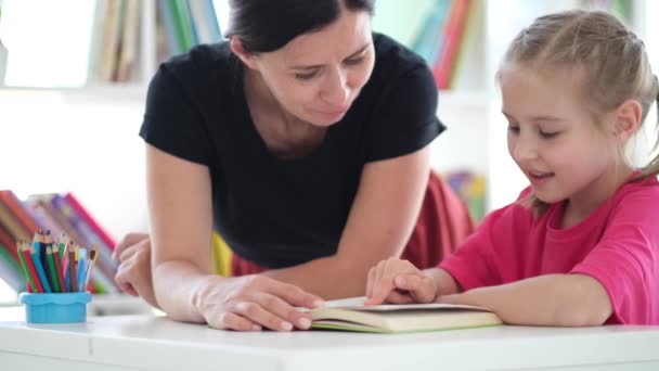 Μικρό κορίτσι ανάγνωση με τη βοήθεια του δασκάλου — Αρχείο Βίντεο