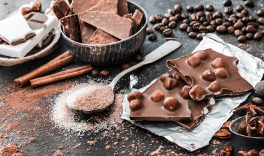 Çikolata ve baharatlar siyah masada.