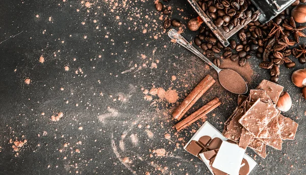 Chocolate, nuts, spices on table — Stock Photo, Image