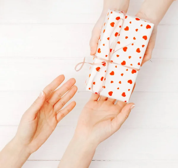 Girls hands holding lovely present box — Stock Photo, Image