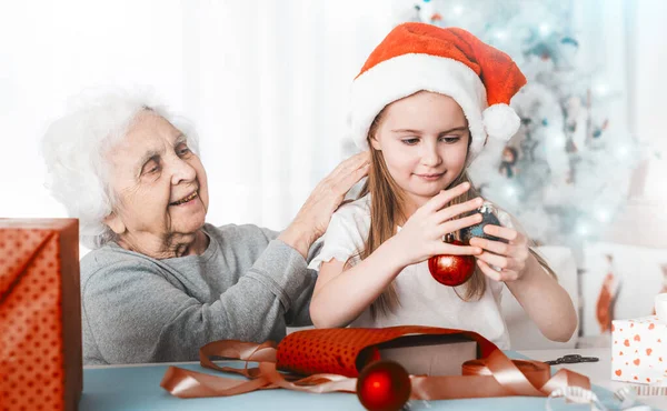 Nieta sentarse con la abuela sosteniendo bolas — Foto de Stock