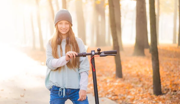 Lovely teenage girl with scooter — Stock Photo, Image