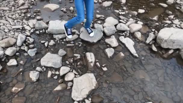 Kleines Kind überquert den Fluss mit dem Stein — Stockvideo