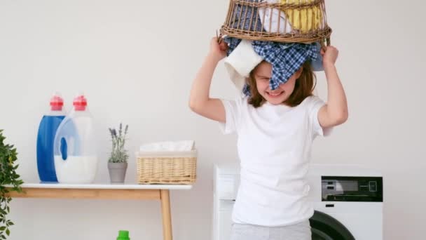 Girl is playing during laundry — Stock Video