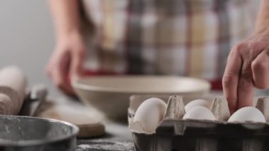 Woman taking egg during baking at home