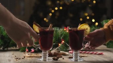 Couple clinking glasses with mulled wine