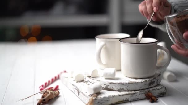 Woman pouring cacao into steel mugs — Stock Video