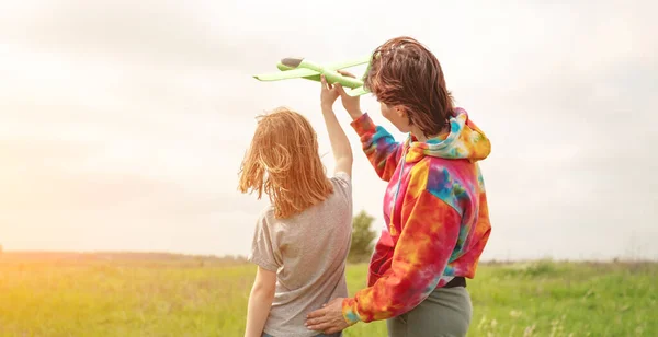 Moeder en dochter spelen met speelgoed vliegtuig — Stockfoto