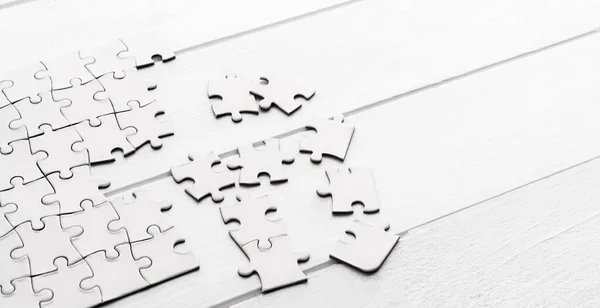 Pieces of empty jigsaw puzzle — Stock Photo, Image