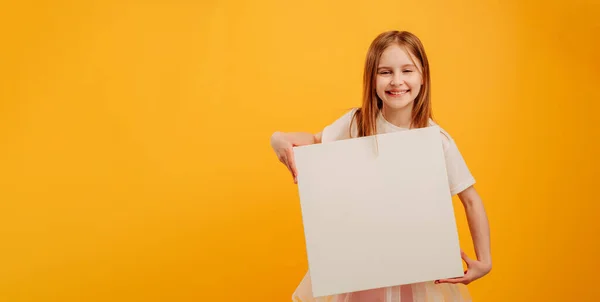 Girl with canvas isolated on yellow background — 图库照片