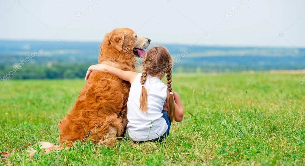 Little girl with golden retriever