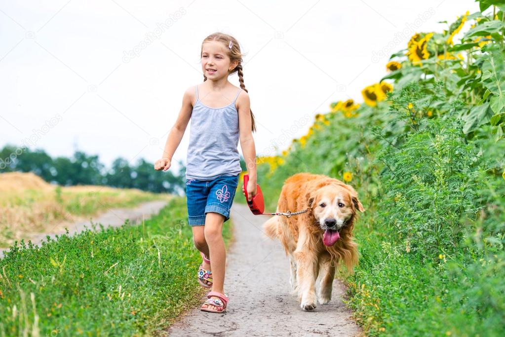 Little girl with golden retriever