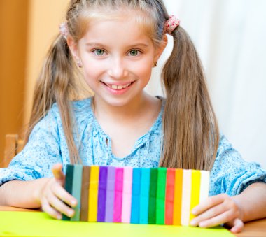 Küçük kız plastikle oynuyor.