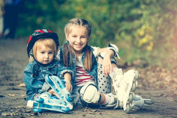 Two sisters on roller skates — Stock Photo, Image