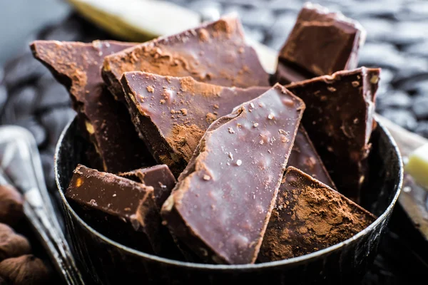Bar of chocolate in a bowl on a table — Stock Photo, Image