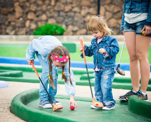 Moeder en dochter golfen op een golfbaan — Stockfoto