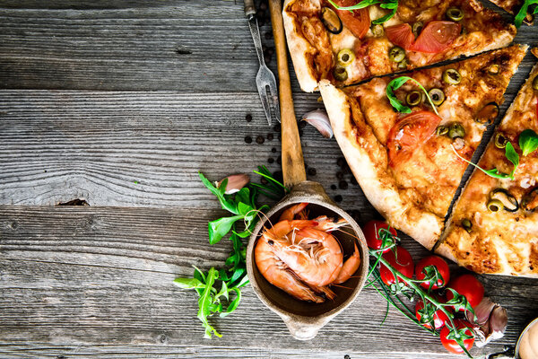 Delicious pizza with seafood on wooden table