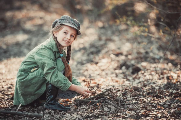 Little girl making a bonfire — Stock Photo, Image