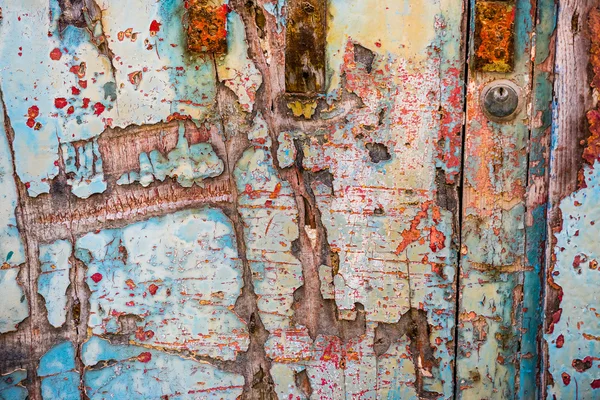 Old wooden door with crumbling paint — Stock Photo, Image