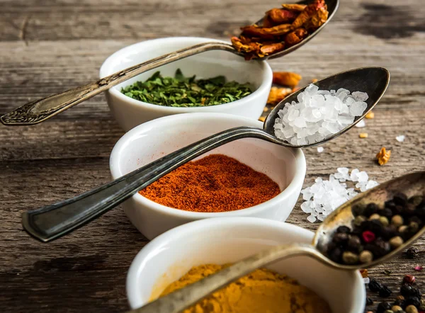 Spicec in bowls and spoons — Stock Photo, Image