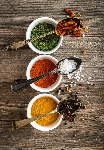 Spicec in bowls and spoons — Stock Photo, Image