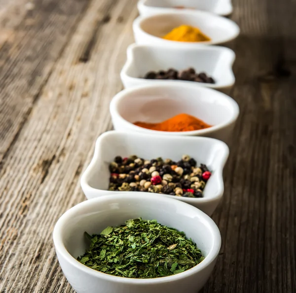 Spices in bowls in a row — Stock Photo, Image