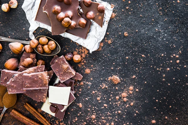 Chocolat and spices on black table — Stock Photo, Image