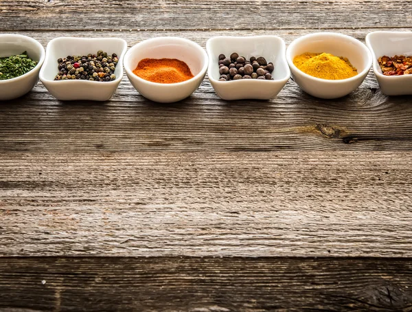 Spices in bowls in horizontal row — Stock Photo, Image