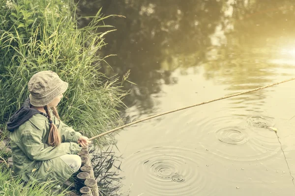 Little fisher on a river bank — Stock Photo, Image