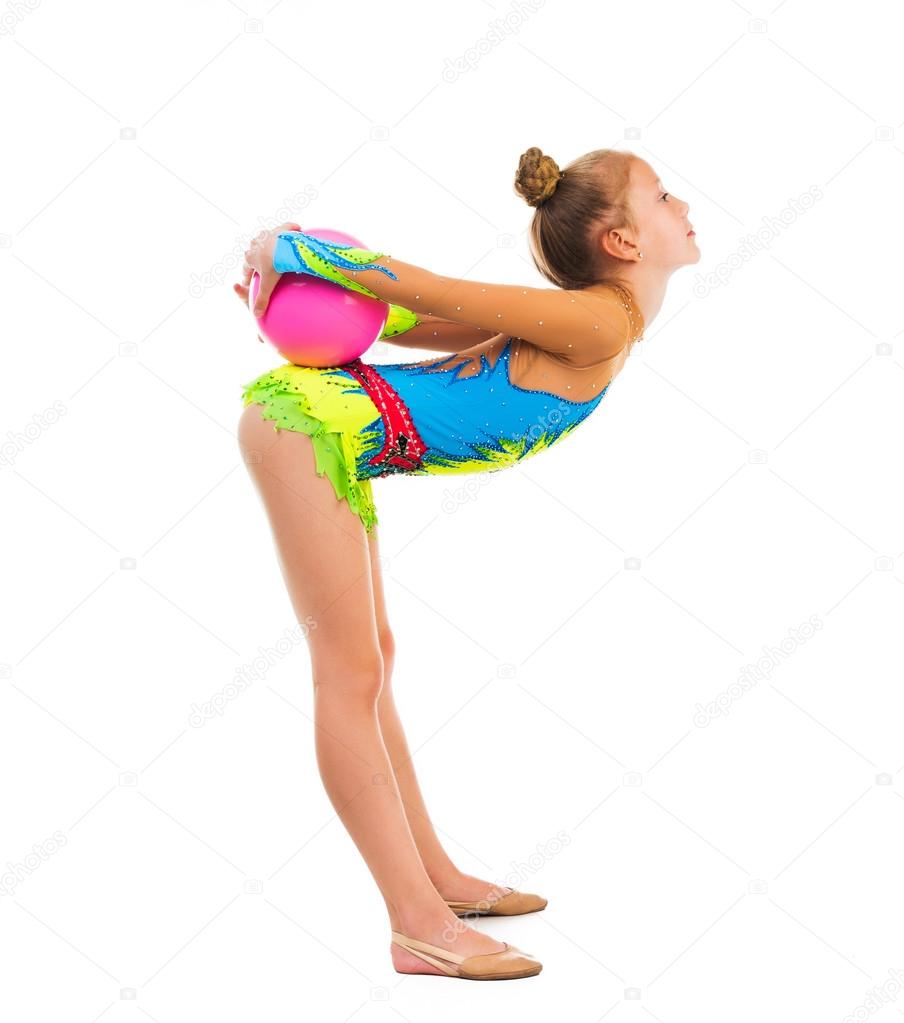 little gymnast doing an exercise with ball