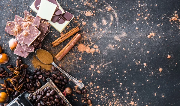 Chocolate, nuts, spices on table — Stock Photo, Image