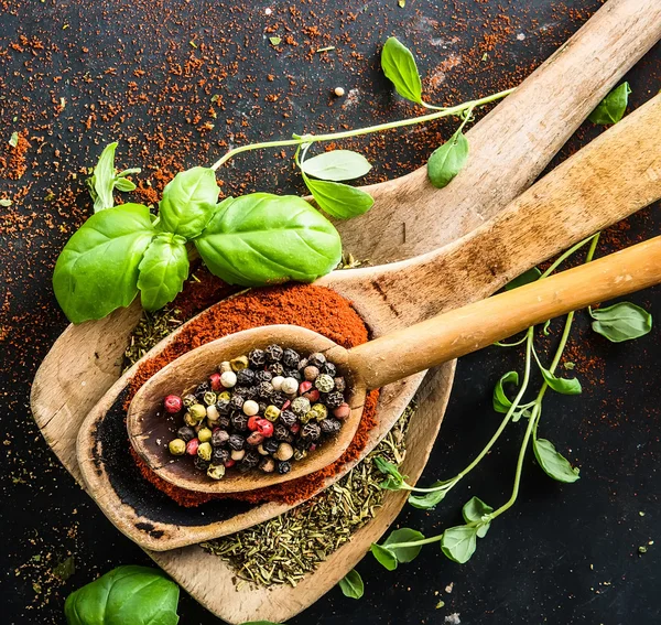 wooden spoons with spices and herbs