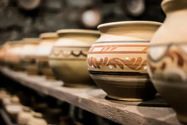 Clay pots on shop shelf — Stock Photo, Image