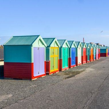 Row of beach huts on sea front in England clipart