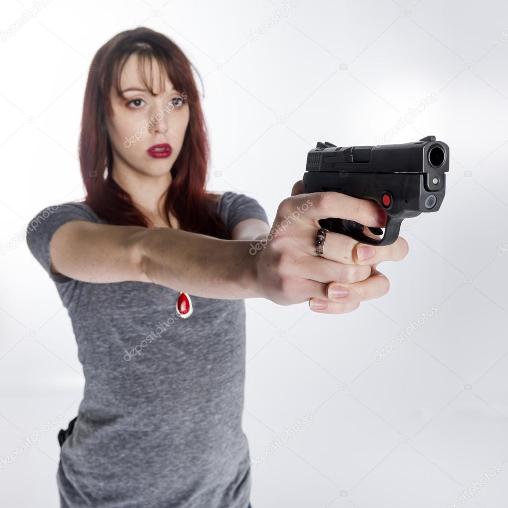Young Woman Holding Hand Gun with Both Hands
