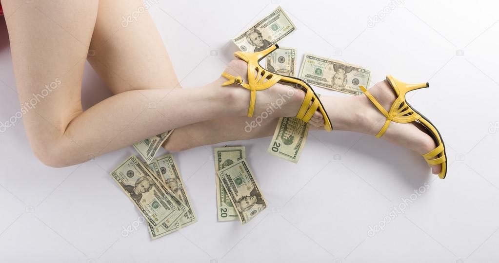 Sexy Woman Legs on the Floor with US Dollars Stock Photo by ©vlue