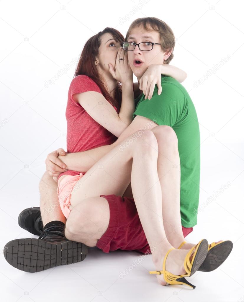 Scared Couple Sitting on the Floor While Hugging
