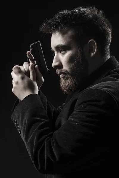 Goatee Young Man With Gun Facing Left — Stock Photo, Image