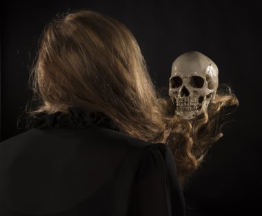 Woman with Blond Hair Holding Skull
