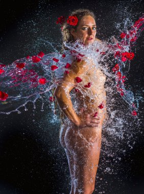 Nude Woman Sprayed with Water and Red Rose Petals