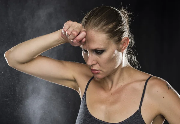 Pensive Sporty Woman with Hand on Forehead — Stockfoto