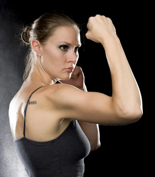 Sporty Woman in Combat Pose Against Black — Stockfoto