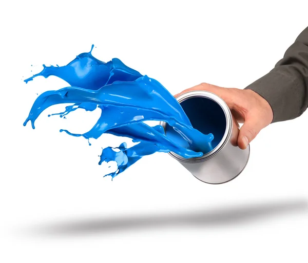 Hand throwing blue paint from can — Stock Photo, Image