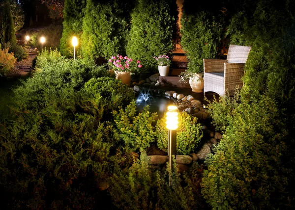 Illuminated home garden fountain patio — Stock Photo, Image