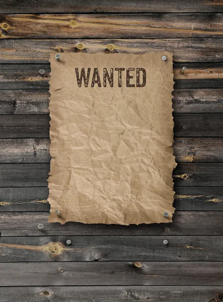 Wanted poster on weathered plank wood wall — Stock Photo, Image