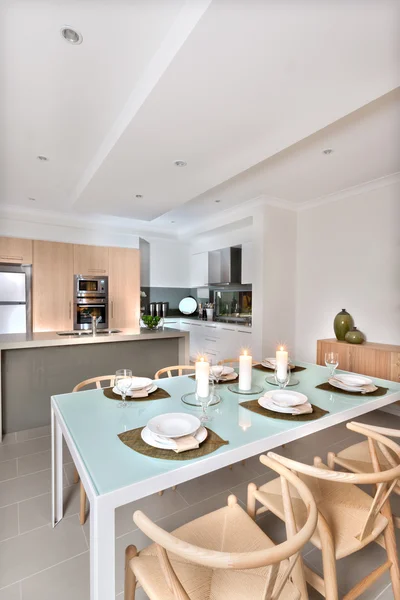 Modern dining room set up with candles flashing in front of the — Stock Photo, Image