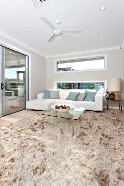 Closeup of a fur carpet on the wooden floor in modern living roo — Stock Photo, Image