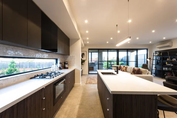 Modern kitchen illuminated with ceiling lights at day time — Stock Photo, Image