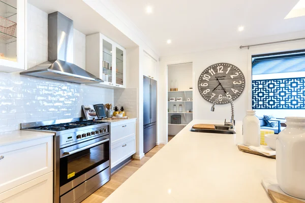 Modern kitchen closeup with countertop and stove under the oven — Stock Photo, Image