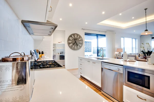 Luxury kitchen with modern items illuminated with sunlight — Stock Photo, Image